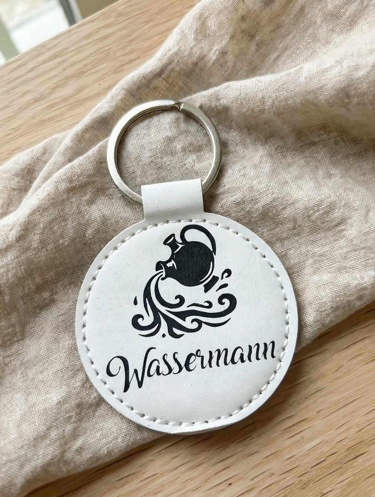 Schlüsselanhänger Sternzeichen Wassermann weiss mit Geheimfach – handgemacht in Hämikon Luzern – schwarzes Wassermann Motiv mit Schriftzug